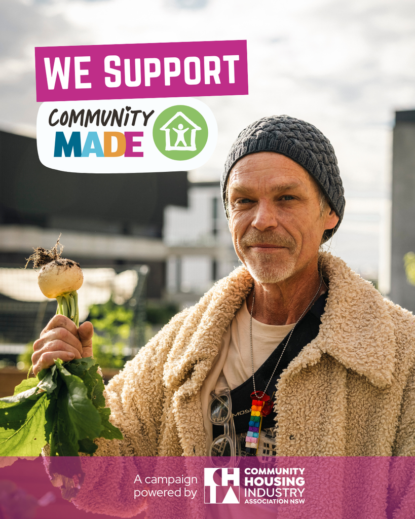 A man holding a turnip he grew with the words We support community made